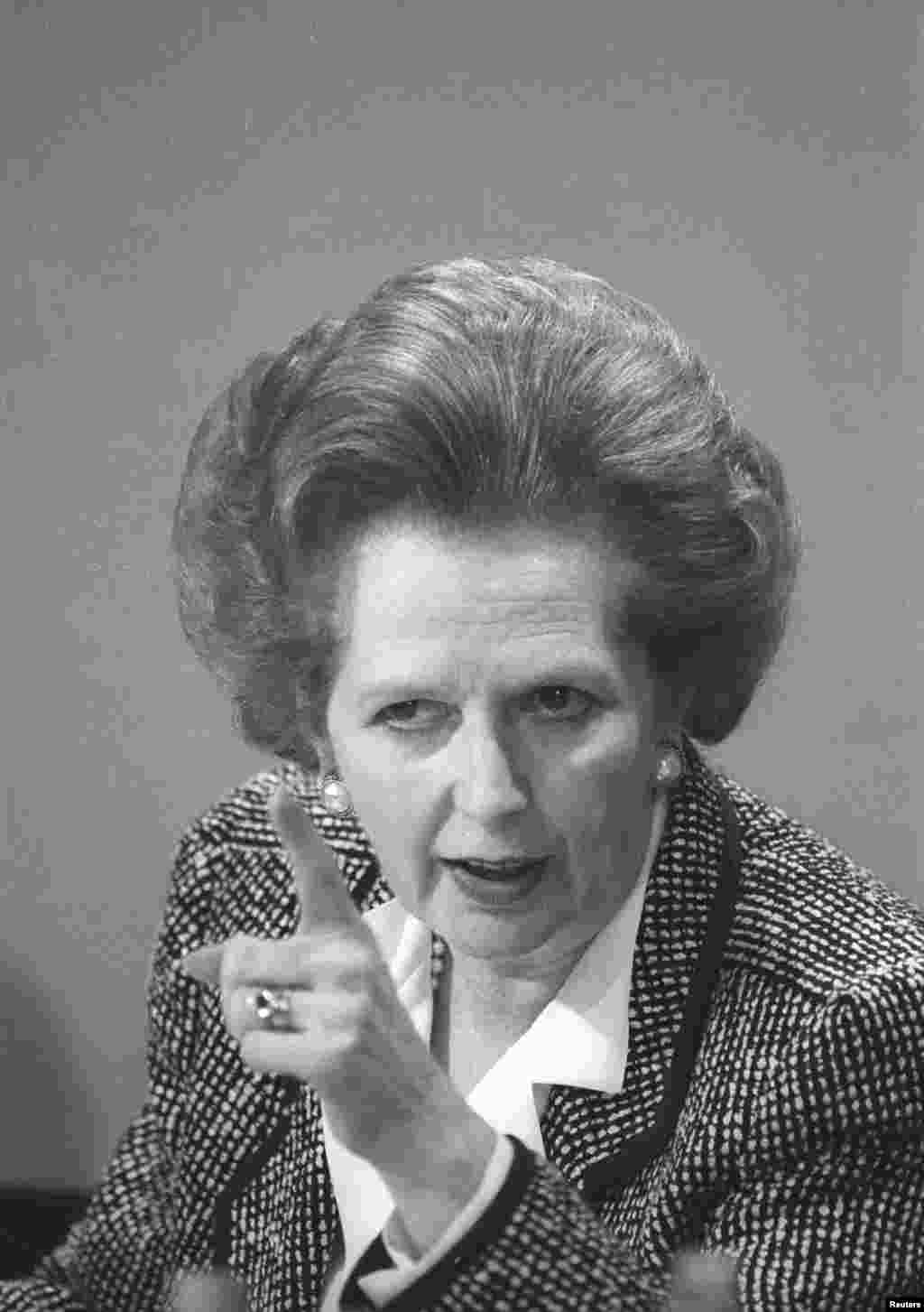 Then British Prime Minister Margaret Thatcher pointed a finger as she answers questions at a news conference in London, June 8, 1987. 