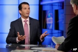 FILE - Donald Trump Jr., left, is interviewed by host Sean Hannity on his Fox News Channel television program, in New York, July 11, 2017.