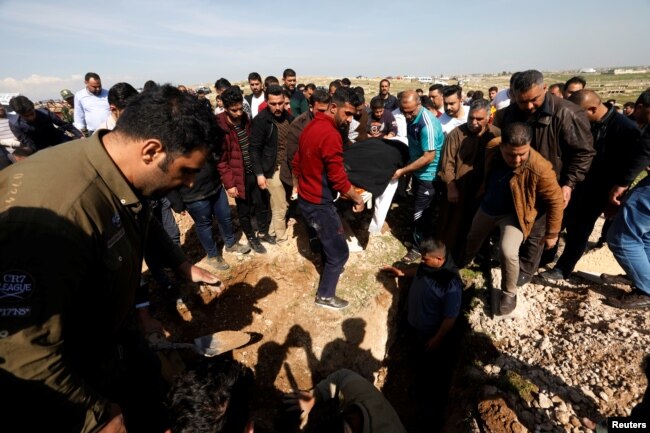Mourners carry one of the victims who died after an overloaded ferry sank in Tigris river near Mosul, during his funeral at Mosul cemetery, Iraq, March 22, 2019.