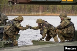 German soldiers from 2 Company Multinational Engineer Battalion of NATO’s Very High Readiness Joint Task Force, man an M3 Amphibious Rig while conducting river crossing training during Exercise Trident Juncture 2018 at Camp Roedsmoen in Rena, Norway, Oct. 25, 2018. Sgt Marc-Andre Gaudreault/NATO JFC Brunssum Imagery/Handout via Reuters.