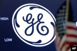 The General Electric logo appears above a trading post on the floor of the New York Stock Exchange, June 26, 2018.