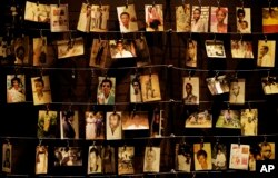 Family photographs of some of those who died hang on display in an exhibition at the Kigali Genocide Memorial centre in the capital Kigali, Rwanda, April 5, 2019.