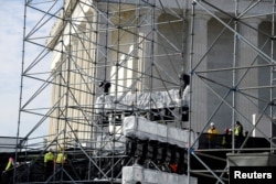 Workmen prepare scaffolding and speakers at the Lincoln Memorial for pre-inaugural programs and festivities in the days prior to Donald J. Trump's inauguration, in Washington, Jan. 15, 2017.