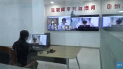Video screens show citizens taking part in an "internet court" system, based in Hangzhou, China. (Courtesy: AFP/YouTube video)