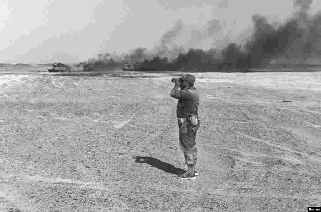 Israeli Major General Ariel Sharon watches an aerial drop through his binoculars in the Sinai Peninsula, then occupied by Israel, during the Middle East War, June 8, 1967.