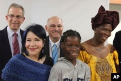 Janet Sylva (second from right) and her mother, Philomena (right) meet with surgeons and others at Cohen Children's Medical Center in New Hyde Park, N.Y., March 9, 2017. The girl and her mother, who are from the West African nation of Gambia, were brought to the United States for the free surgery by the charity The Global Medical Relief Fund. Also pictured (from left) are Dr. David Hoffman, Elissa Montanti of the Global Medical Relief Fund, and Dr. Armen Kasabian of North Shore University Hospital.