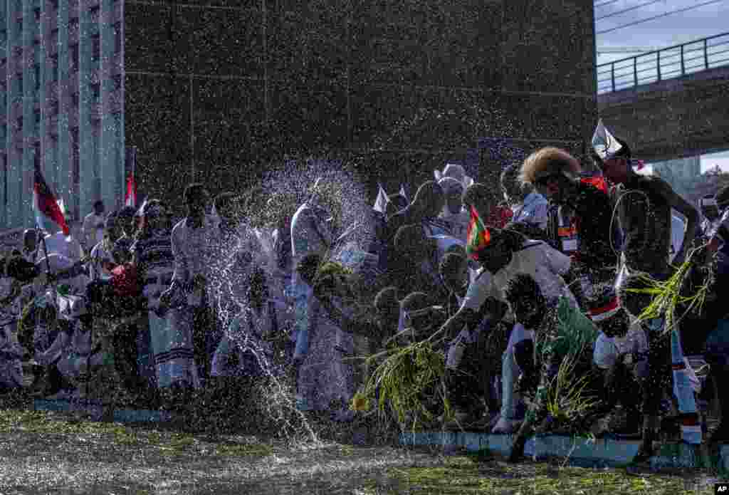 اهالی آدیس آبابا، پایتخت اتیوپی، در جشنواره شکرگزاری طی مراسمی نمادین برای سپاس از بارش باران دسته&zwnj;هایی از گیاهان را به آب یک استخر می زنند.