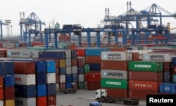 FILE - Containers are loaded at a port in Ho Chi Minh City, Vietnam July 27, 2018.