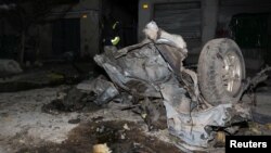 The wreckage of a car destroyed in an explosion rests outside Darishifa hospital in Mogadishu, Somalia, Aug. 4, 2017. 