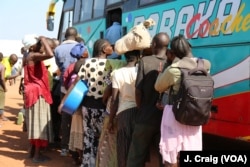 South Sudanese refugees wait to board a bus from the Kuluba collection point near the Busia border point for relocation to the Imvepi refugee settlement. Photo taken April 1 in Koboko, Uganda.