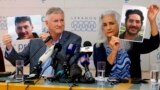 FILE - Marc and Debra Tice, the parents of Austin Tice, who has been missing in Syria since August 2012, hold up photos of him during a news conference at the Press Club in Beirut, Lebanon, July 20, 2017. 