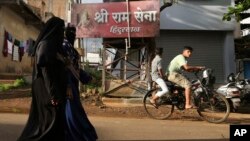 FILE - Muslim women walk in a residential neighborhood in Belagavi, India, Oct. 7, 2021. Police in India have arrested a man alleged to be behind an online 'auction' of pictures of Muslim women in a case of apparent hatred toward the minority community.