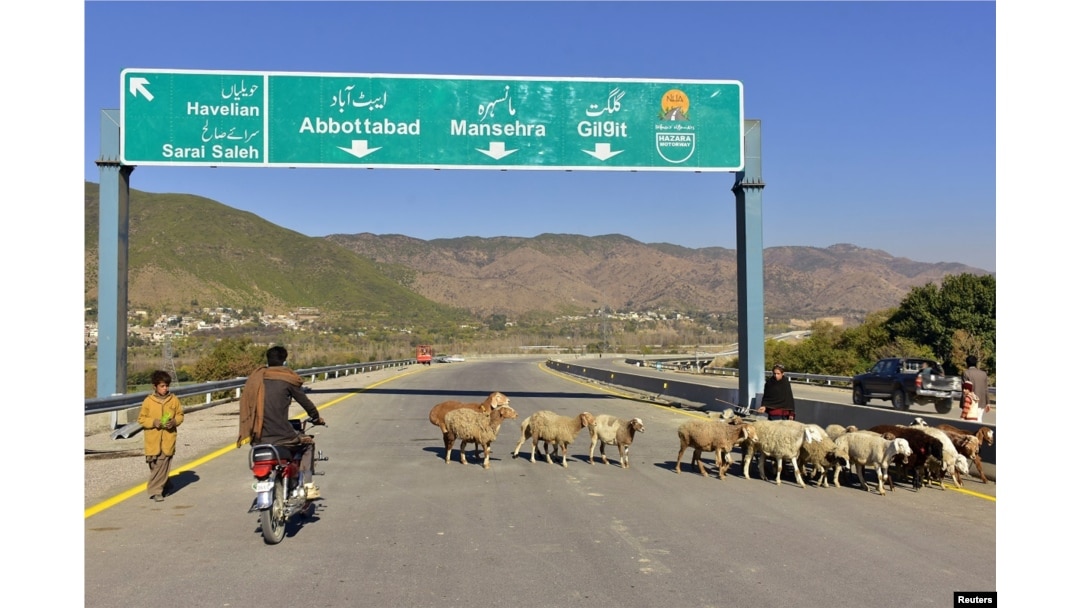 FILE - A Pakistani motorcyclist drives on a newly built Pakistan China Silk Road in Haripur, Pakistan, Dec. 22, 2017.