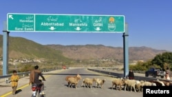 A Pakistani motorcyclist drives on a newly built Pakistan China Silk Road in Haripur, Pakistan, Dec. 22, 2017.