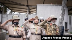 War veterans salute as people gather during a protest against purported fake news and foreign meddling at the British Embassy of Ethiopia in Addis Ababa, Ethiopia, Nov. 25, 2021.