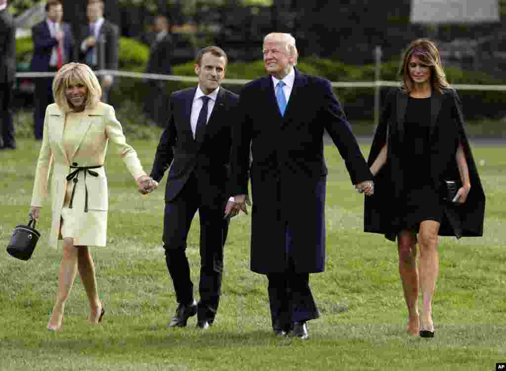 President Donald Trump and first lady Melania Trump walk on the South Lawn with French President Emmanuel Macron and his wife Brigitte Macron at the White House, April 23, 2018, in Washington.