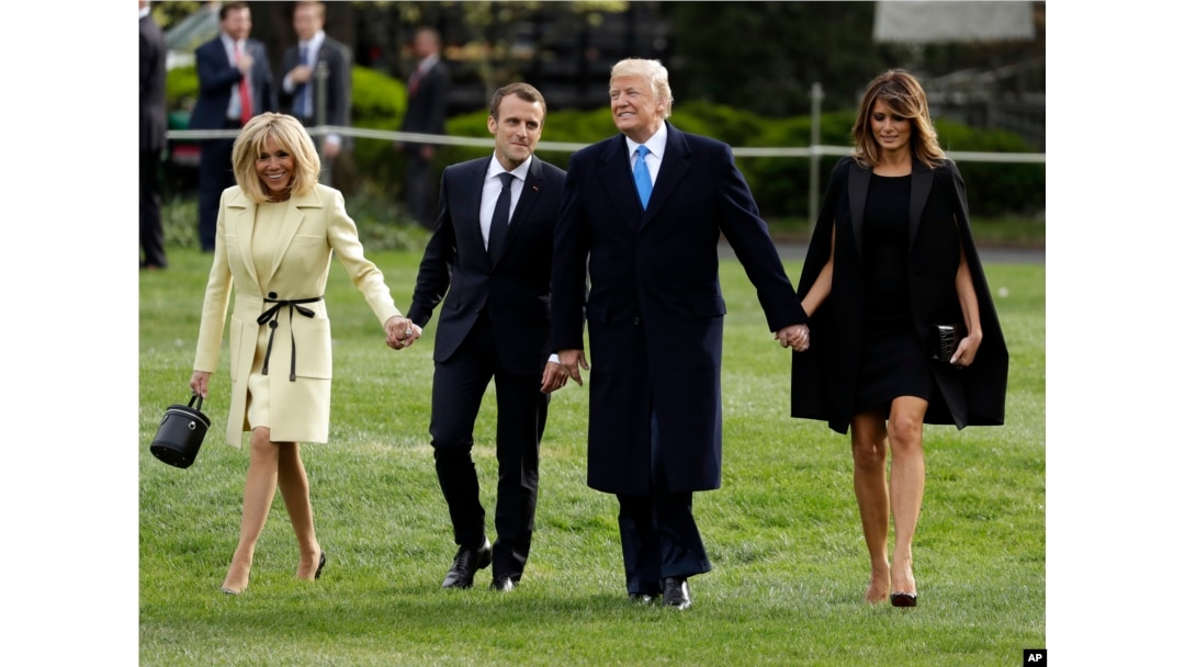 President Donald Trump and first lady Melania Trump walk on the South Lawn with French President Emmanuel Macron and his wife Brigitte Macron at the White House, April 23, 2018, in Washington.