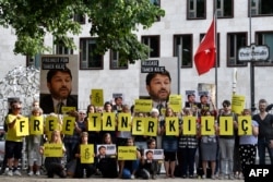 FILE - Activists of Amnesty International stage a protest against the detention of the head of Amnesty International in Turkey, Taner Kilic, in front of the Turkish Embassy in Berlin on June 15, 2017.