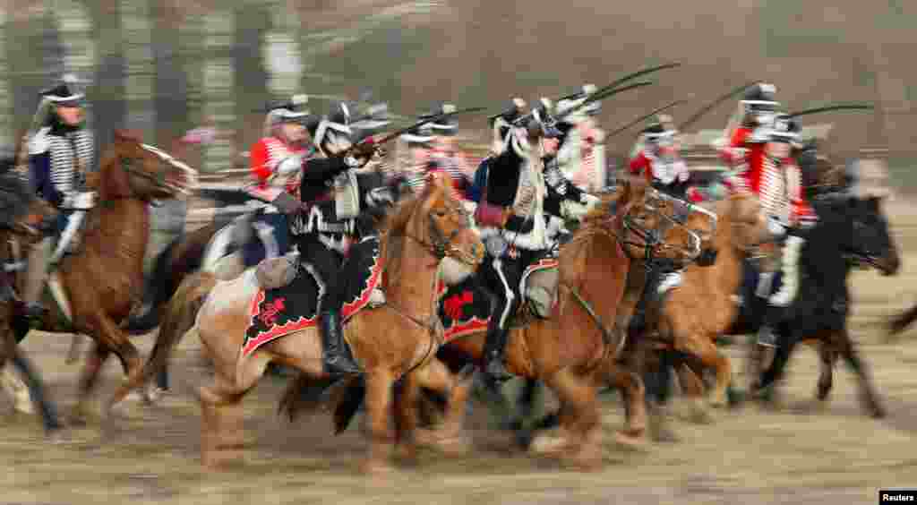 People dressed in the historic uniforms of the Imperial Russian and French armies take part in a re-enactment of the 1812 Battle of Berezina, to mark the 207th anniversary of the battle, near the village of Bryli, Belarus.