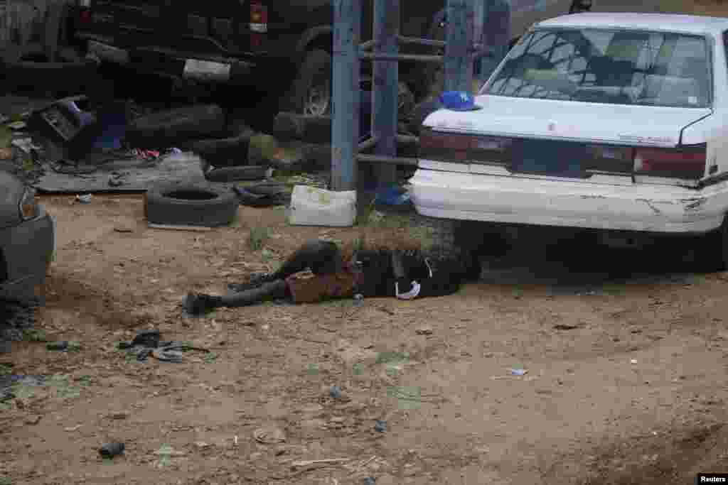 A man, who according to a member of Doctors Without Borders (MSF), was thought to be carrying the Ebola virus, lies dead on a street in Monrovia, Liberia, Sept. 9, 2014.