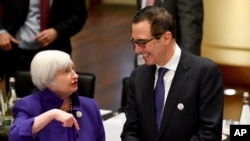 Janet Yellen, president of the Federal Reserve Board, and U.S. Treasury Secretary Steven Mnuchin talk to each other during the G20 finance ministers meeting in Baden-Baden, Germany, March 17, 2017.