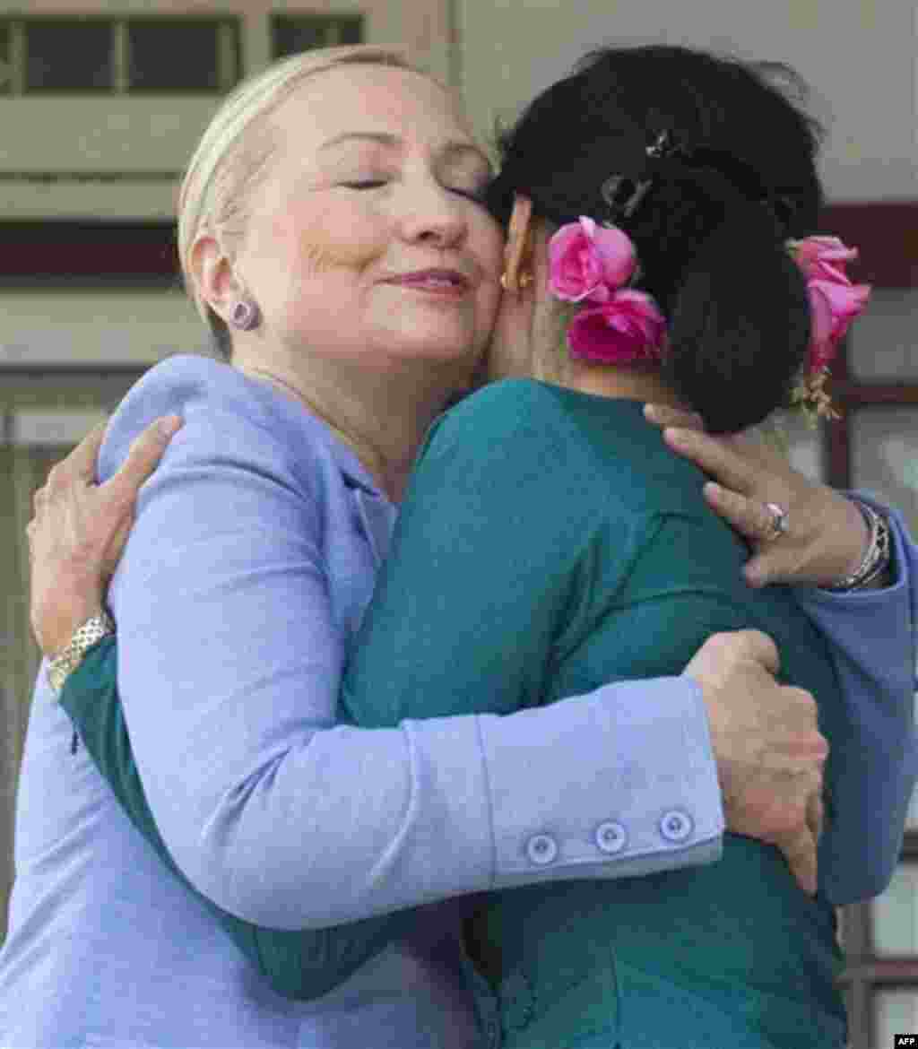 Myanmar's pro-democracy opposition leader Aung San Suu Kyi, right, and U.S. Secretary of State Hillary Rodham Clinton hug after meetings at Suu Kyi's residence in Yangon, Myanmar Friday, Dec. 2, 2011. (AP Photo/Saul Loeb, Pool)