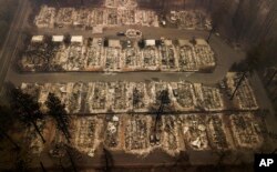 FILE - Homes were leveled by the wildfire in Paradise, Calif., Nov. 15, 2018.