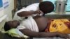 An employee at the Health Care center IV of Busiu in Mbale district, eastern Uganda attends to Mary Watera, who is pregnant with her first baby, September 27, 2011.