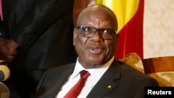 FILE - Mali's President Ibrahim Boubacar Keita answers a question upon his arrival at Algiers airport, Jan. 18, 2014.