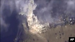 This photo made from footage taken from the Russian Defense Ministry official websiteNov. 2, 2015, shows a Russian airstrike hit a target in Syria. The Russian Defense Ministry said the strike was performed by an Su-34M bomber in Aleppo province. 