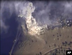 This photo made from footage taken from the Russian Defense Ministry official website on Nov. 2, 2015, shows a Russian airstrike hit a target in Syria.