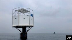 This photo provided by Royal Thai Navy, shows a floating home lived in by an American man and his Thai partner in the Andaman Sea, off Phuket island, Thailand, April 13, 2019.