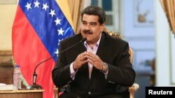 Venezuela's President Nicolas Maduro speaks during a meeting with members of the Venezuelan diplomatic corp after their arrival from the United States, at the Miraflores Palace in Caracas, Venezuela Jan. 28, 2019. 