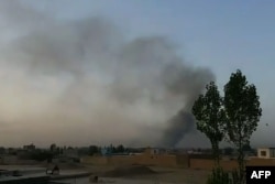 This screen grab taken from AFPTV video on August 10, 2018 shows smoke rising into the air after Taliban militants launched an attack on the Afghan provincial capital Ghazni.