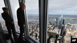 Tom Hennes, right, designer of the 102nd floor observatory of the Empire State Building, looks toward the west view, Thursday, Oct. 10, 2019. (AP Photo/Richard Drew)