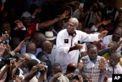 Congo opposition candidate Martin Fayulu greets supporters as he arrives at a rally in Kinshasha, Congo, Jan. 11, 2019.