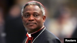 Cardinal Peter Kodwo Appiah Turkson of Ghana arrives to attend a mass led by bishop Leonardo Sandri of Argentina in St. Peter's Basilica at the Vatican, April 13, 2005.