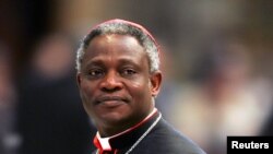 Cardinal Peter Kodwo Appiah Turkson of Ghana arrives to attend a mass led by bishop Leonardo Sandri of Argentina in St. Peter's Basilica at the Vatican, April 13, 2005.