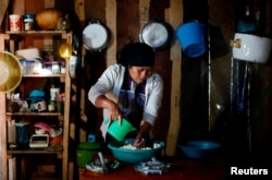 Karima Gomez, 66, a Muslim from the Tzotzil Maya ethnic group, cooks tortillas inside her house in San Cristobal de las Casas, in Chiapas state, Mexico, Aug. 12, 2017.