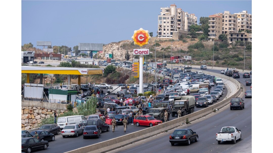 Cars come from every direction to fill their tanks with gasoline at a petrol station on the main highway in the coastal town of Jiyeh, south of Beirut, Lebanon, Sept. 3, 2021.