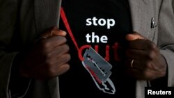 FILE - A T-shirt warns against female genital mutilation. Its wearer attends an event, discouraging harmful practices such as FGM, at a girls high school in Imbirikani, Kenya, April 21, 2016. (REUTERS/Siegfried Modola)