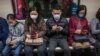 People wear masks on a train on the first day of the Lunar New Year of the Rat in Hong Kong on January 25, 2020, as a preventative measure following a coronavirus outbreak which began in the Chinese city of Wuhan.