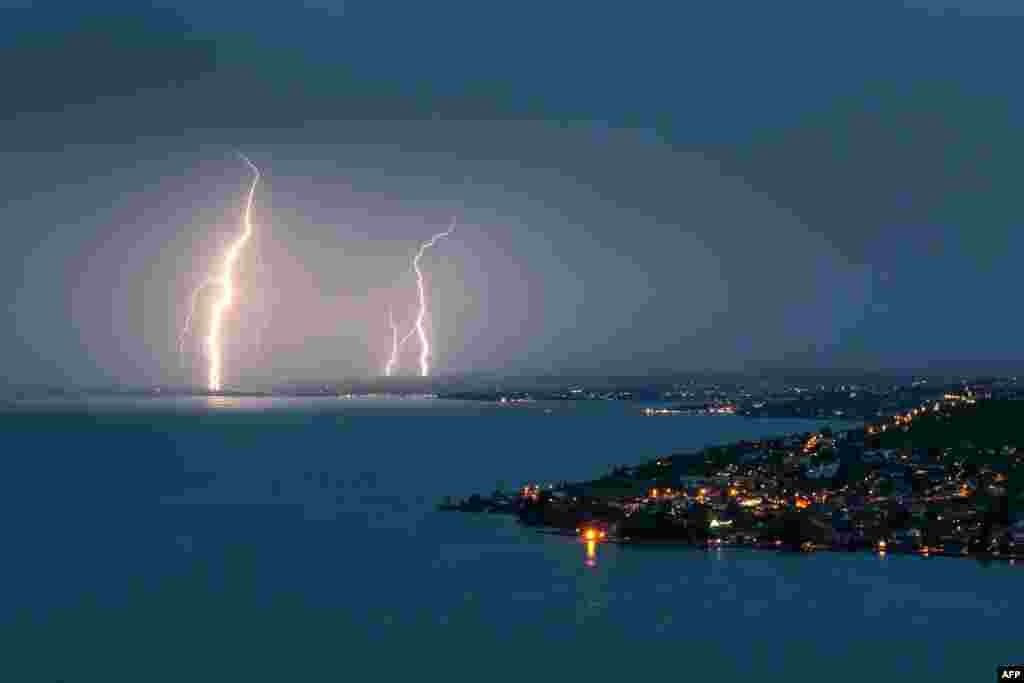 Lightning illuminates the night sky over the village of Cully on the bank of Leman Lake, Switzerland, July 30, 2017.