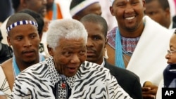 Former South African President Nelson Mandela, centre, followed by his grandson Mandla Mandela, rear right, arrives at a ceremony in Mvezo, South Africa, April 16, 2007.