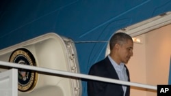 President Barack Obama boards Air Force One before his departure from Andrews Air Force Base, Sunday, March 23, 2014. 