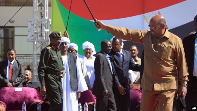 Sudan’s President Omar al-Bashir greets supporters at a rally in Khartoum, Sudan, Wednesday, Jan. 9, 2019.