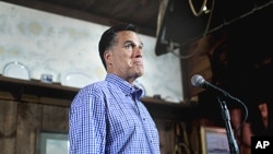 Republican presidential candidate, former Massachusetts Governor Mitt Romney holds news conference after talking with local business owners at a town hall meeting in Hampton, New Hampshire, July 5, 2011