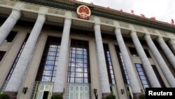 An officer stands outside the Great Hall of the People, the venue of National People's Congress, China's parliament, in Beijing, June 18, 2015.