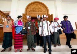 Clad in ethnic Chin and Myanmar traditional attire, newly elected members of parliament from Myanmar opposition leader Aung San Suu Kyi's National League for Democracy party gather at the Lower House of parliament in Naypyitaw, Myanmar, Jan. 27, 2016.