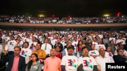 Attendees stand as India's Prime Minister Narendra Modi arrives to speak at Madison Square Garden in New York Sept. 28, 2014.